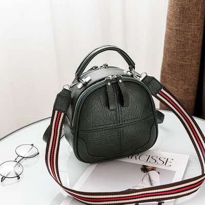

A girl with a double shoulder bag a broadband shoulder bag a Korean version of a backpack a girl slanted a small round bag and