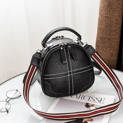 

A girl with a double shoulder bag a broadband shoulder bag a Korean version of a backpack a girl slanted a small round bag and