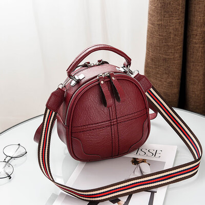 

A girl with a double shoulder bag a broadband shoulder bag a Korean version of a backpack a girl slanted a small round bag and
