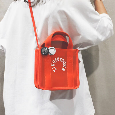 

Portable transparent bag canvas bag handbags new 2019 students Korean version of the slung Japanese girls cute shoulder bag tide