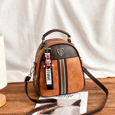

Send pendants shoulder bag female new wave Korean version of fashion wild bag travel PU small backpack female bag