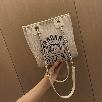 

Canvas bag female Korean version of the wild chain bill of lading backpack fashion letter cartoon tote bag