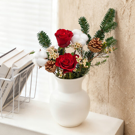 The first snow in winter, roses and pine cones mixed flowers are perfect for Christmas