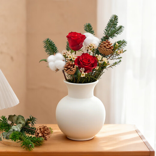 The first snow in winter, roses and pine cones mixed flowers are perfect for Christmas