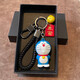 Doraemon Dingdang Cat Figure Car Keychain Cute Cartoon Men and Women Couple School Bag Pendant Gift Laughing Cat + Three Red Ropes + Red An + Gun Eight Gift Box