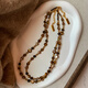 YIZUN. CHOMEL Maillard wear tiger eye stone beaded necklace women's autumn and winter 2024 new light luxury niche versatile sweater chain suit