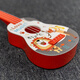 Lige Calidad alemana Ukulele Juguetes de guitarra para niños Pequeño instrumento de guitarra Música Educación temprana Regalos de cumpleaños de bebés Cigarrillo Polvo Superman Pig Girl