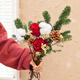 The first snow in winter, roses and pine cones mixed flowers are perfect for Christmas